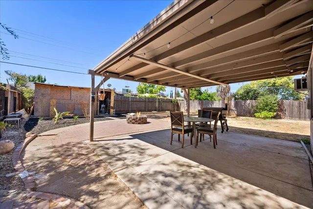 a patio with a table and chairs