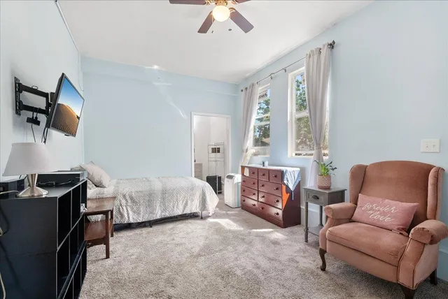 a bedroom with furniture and a flat screen tv