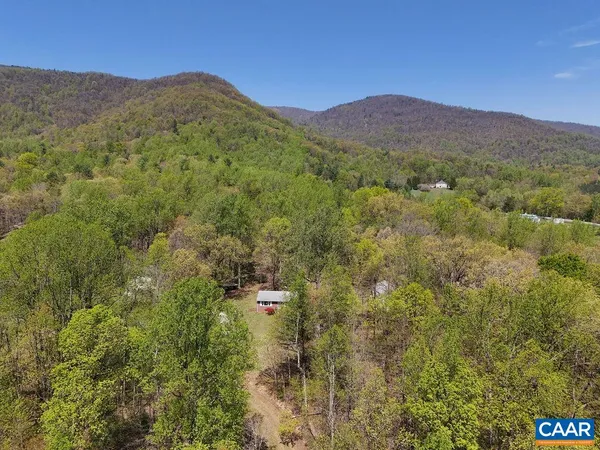 a view of a house with a mountain in the background