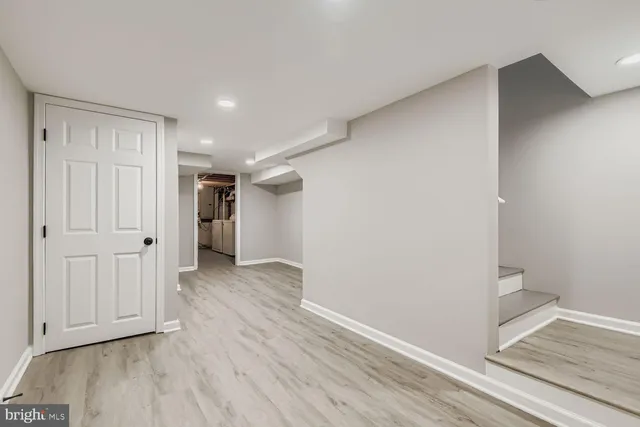 a view of a room with wooden floor