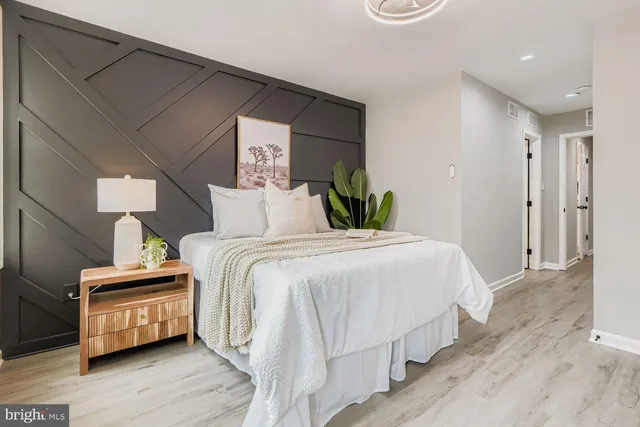 a bedroom with bed and wooden floor