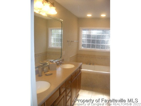 2965 Middlesex Road Fayetteville, NC 28306 - Photo 12 of 25 a bathroom with a tub sink and mirror