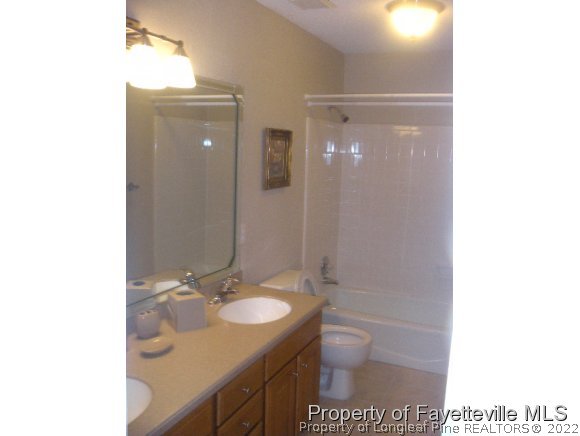 2965 Middlesex Road Fayetteville, NC 28306 - Photo 13 of 25 a bathroom with a sink toilet and shower