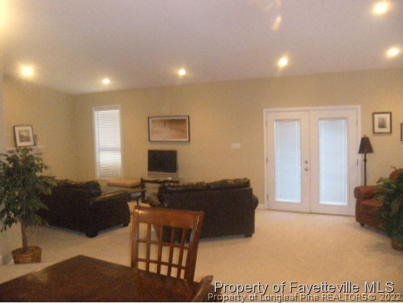 2965 Middlesex Road Fayetteville, NC 28306 - Photo 18 of 25 a living room with furniture a flat screen tv and a window
