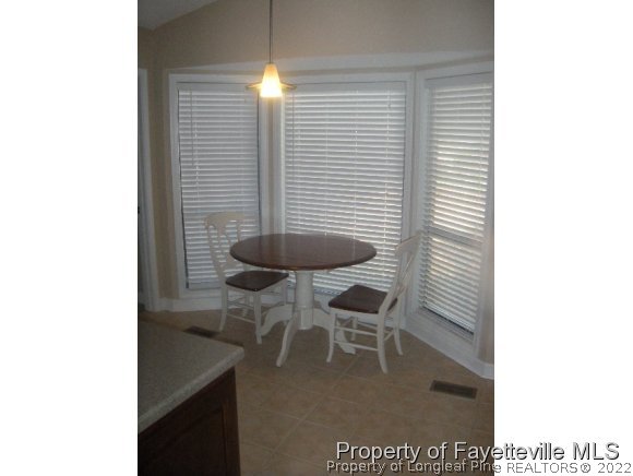 2965 Middlesex Road Fayetteville, NC 28306 - Photo 20 of 25 a dining room with furniture and a potted plant