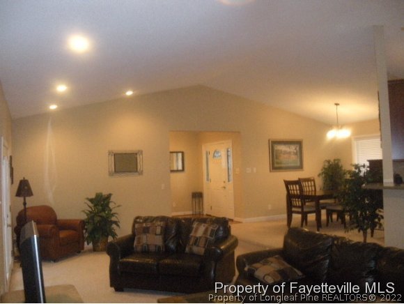 2965 Middlesex Road Fayetteville, NC 28306 - Photo 2 of 25 a living room with furniture and a dining table with wooden floor