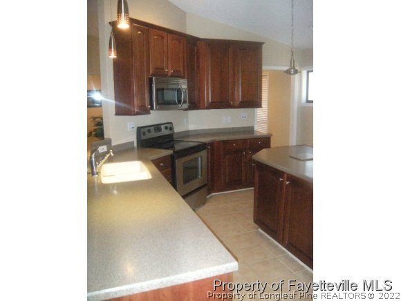 2965 Middlesex Road Fayetteville, NC 28306 - Photo 21 of 25 a kitchen with stainless steel appliances granite countertop a stove a sink and a refrigerator