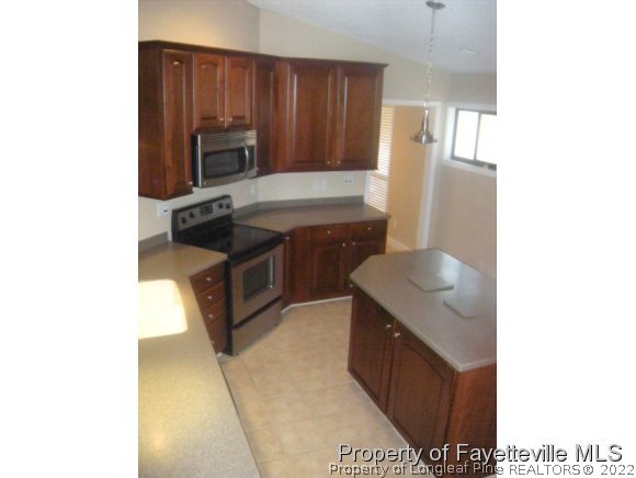 2965 Middlesex Road Fayetteville, NC 28306 - Photo 24 of 25 a kitchen with stainless steel appliances granite countertop a sink stove and refrigerator