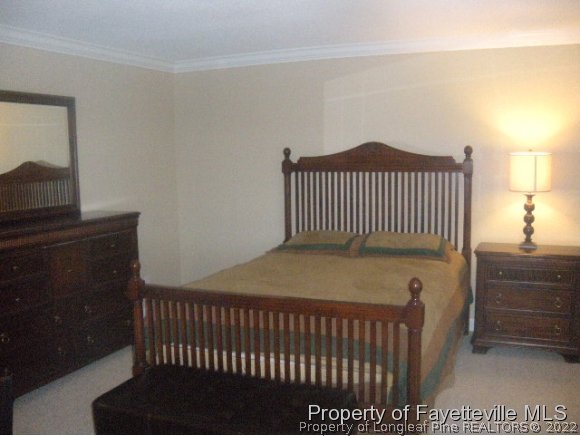 2965 Middlesex Road Fayetteville, NC 28306 - Photo 6 of 25 a bedroom with a bed and wooden floor