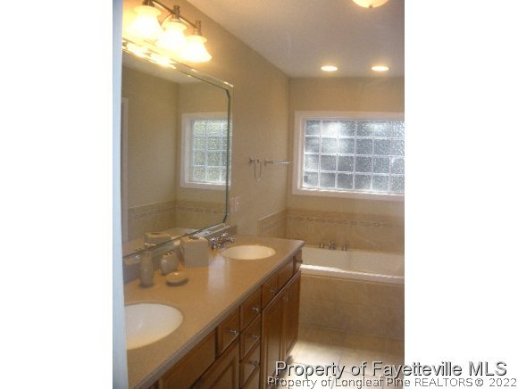 2965 Middlesex Road Fayetteville, NC 28306 - Photo 8 of 25 a bathroom with a sink a toilet and shower