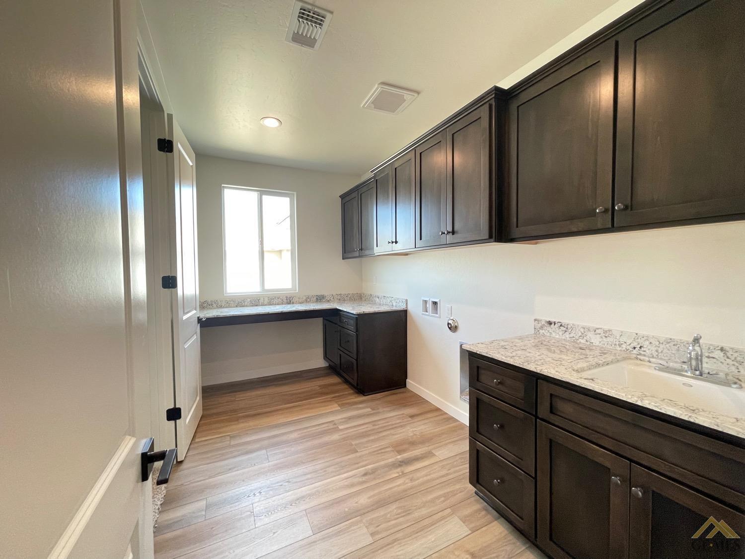 Undisclosed Address Bakersfield, CA 93314 - Photo 13 of 19 Large laundry room with sink, work station and tons of natural light.