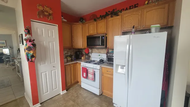 a kitchen with stainless steel appliances a refrigerator a stove and a sink