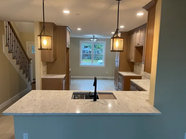 a view of a living room with furniture and a chandelier