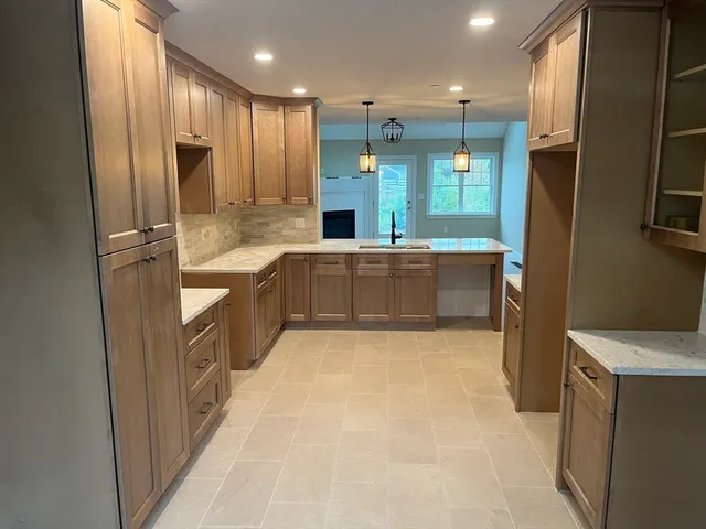 a large kitchen with stainless steel appliances a refrigerator and a stove