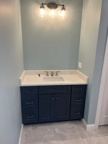 a bathroom with a sink vanity and a mirror
