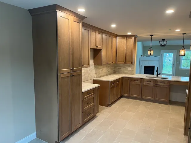 a large kitchen with a sink and cabinets