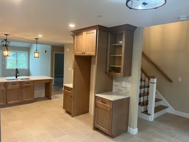 a kitchen with refrigerator and cabinets