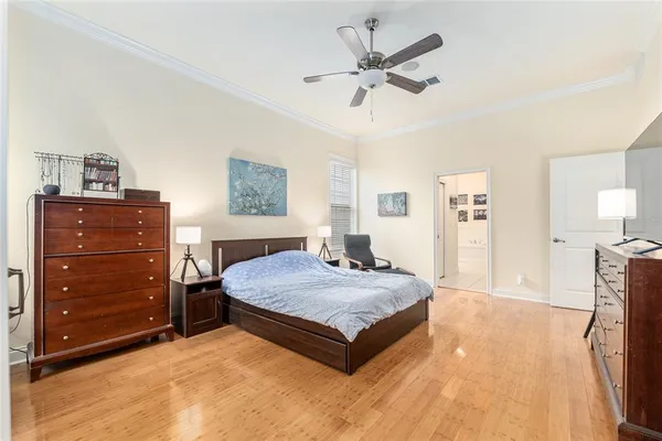 a spacious bedroom with a bed and a chandelier