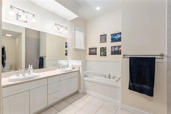 a bathroom with a sink a tub and a mirror