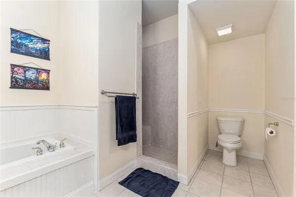 a bathroom with a toilet a sink and shower