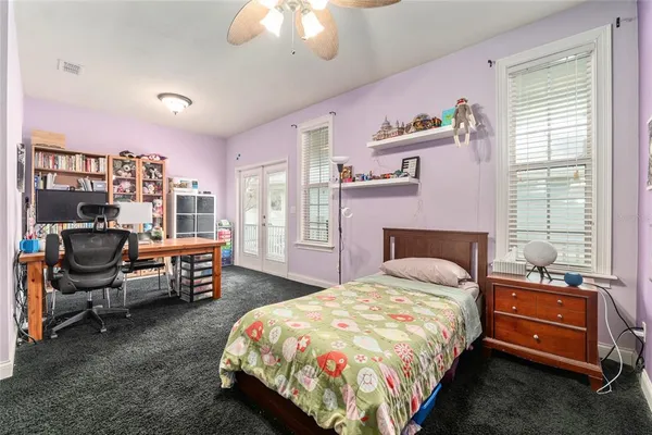 a bedroom with a bed and a chandelier