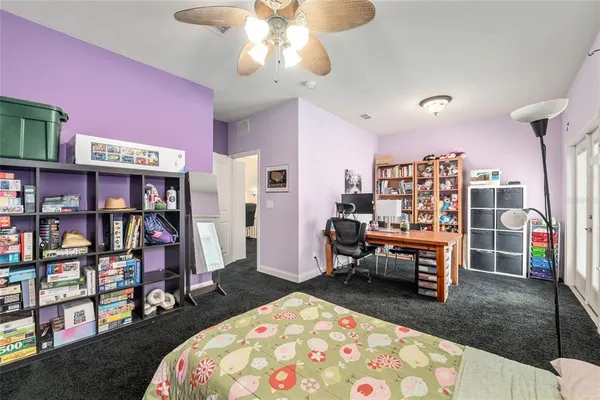 a bedroom with a bed and a book shelf