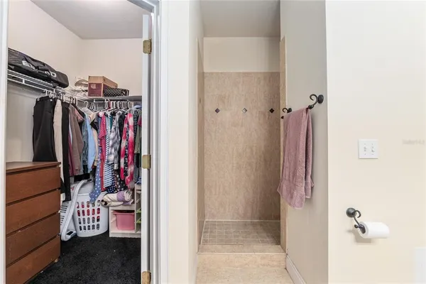 a view of walk in closet with clothes