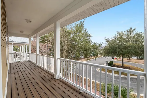 a view of a balcony with wooden floor