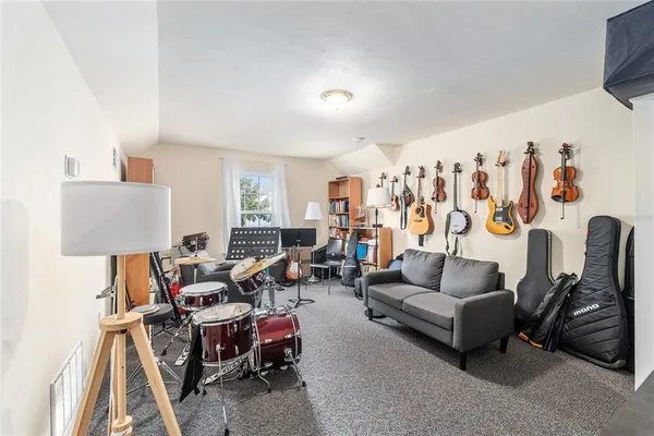a living room with furniture a couch and a flat screen tv