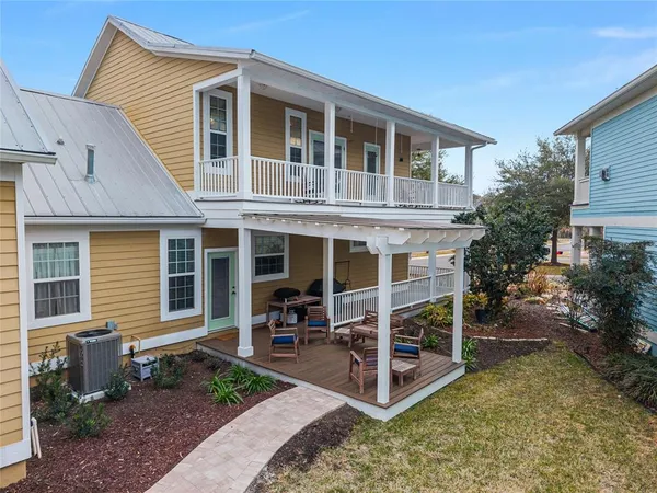 a view of a house with a yard and balcony