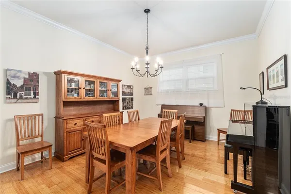 a view of a dining room with furniture and a chandelier