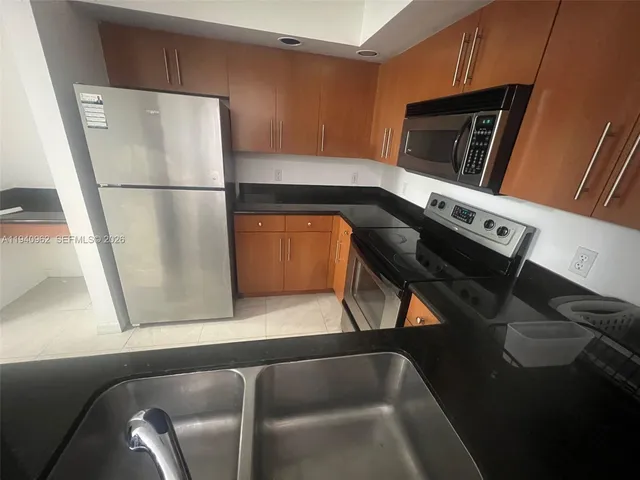 a kitchen with a refrigerator and a microwave