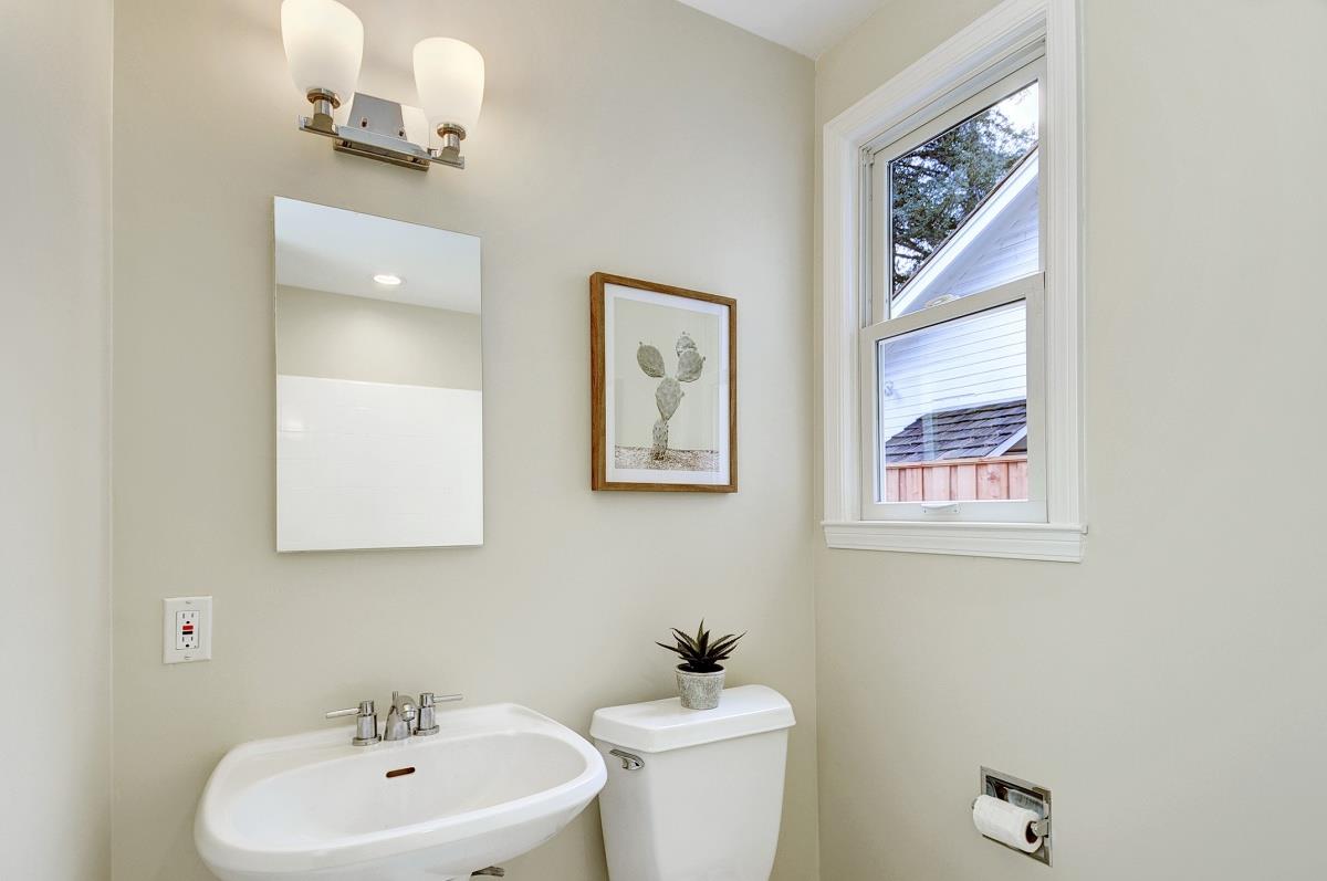 635 California Street Mountain View, CA 94041 - Photo 18 of 25 a bathroom with a toilet a sink and mirror