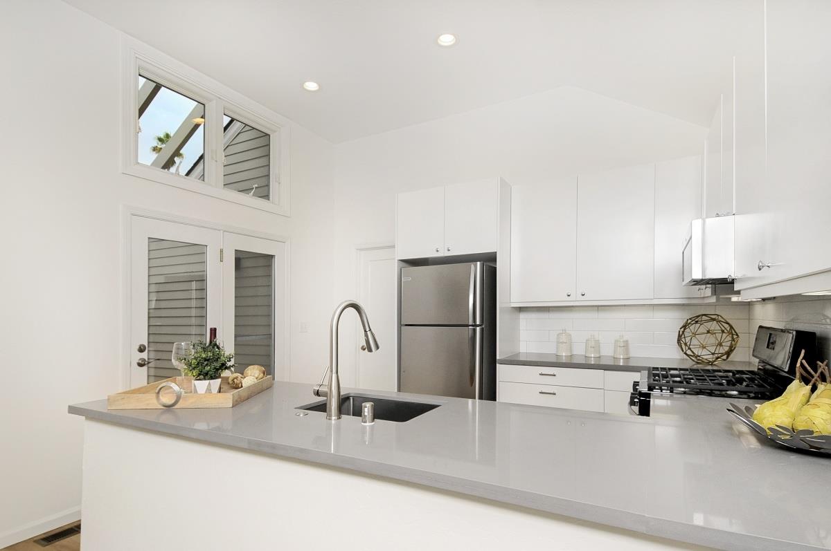 635 California Street Mountain View, CA 94041 - Photo 9 of 25 a kitchen with a sink and a refrigerator