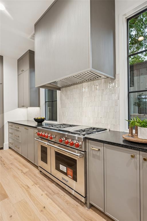 4901 Hanover Avenue Dallas, TX 75209 - Photo 14 of 30 a kitchen with stainless steel appliances a stove and white cabinets