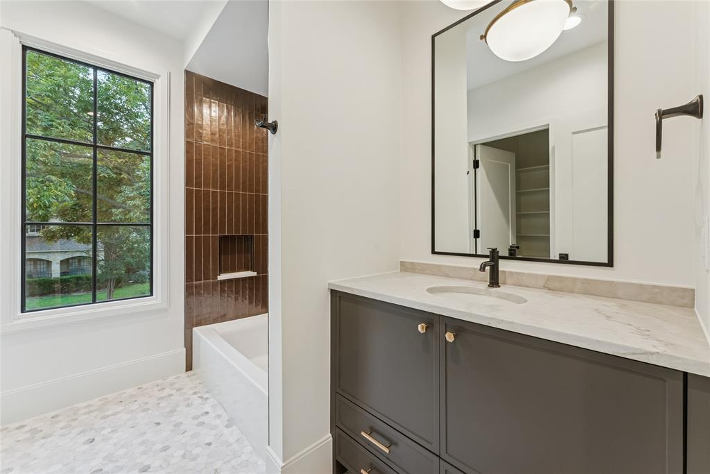 4901 Hanover Avenue Dallas, TX 75209 - Photo 25 of 30 a bathroom with a granite countertop sink and a mirror