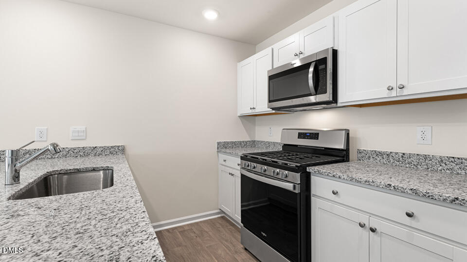17 Bee Garden Angier, NC 27501 - Photo 4 of 33 a kitchen with a stove and a microwave