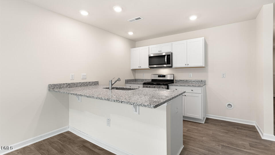 17 Bee Garden Angier, NC 27501 - Photo 5 of 33 a kitchen with appliances cabinets and a sink