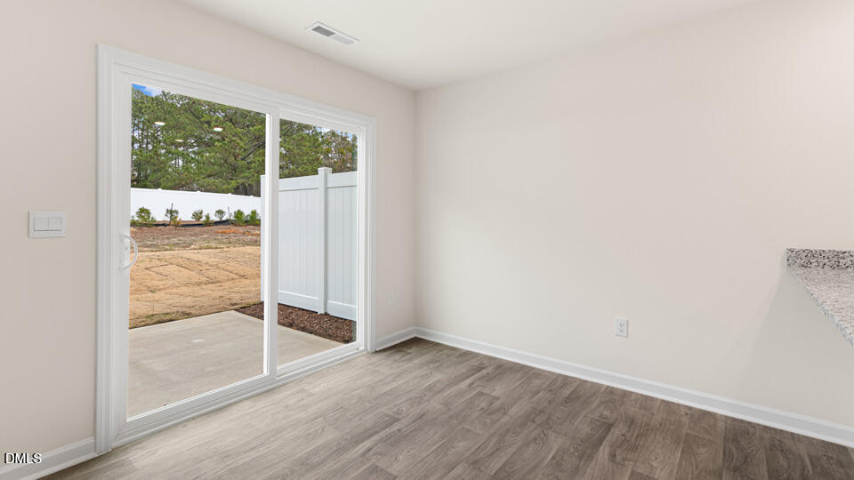 17 Bee Garden Angier, NC 27501 - Photo 8 of 33 an empty room with wooden floor and windows