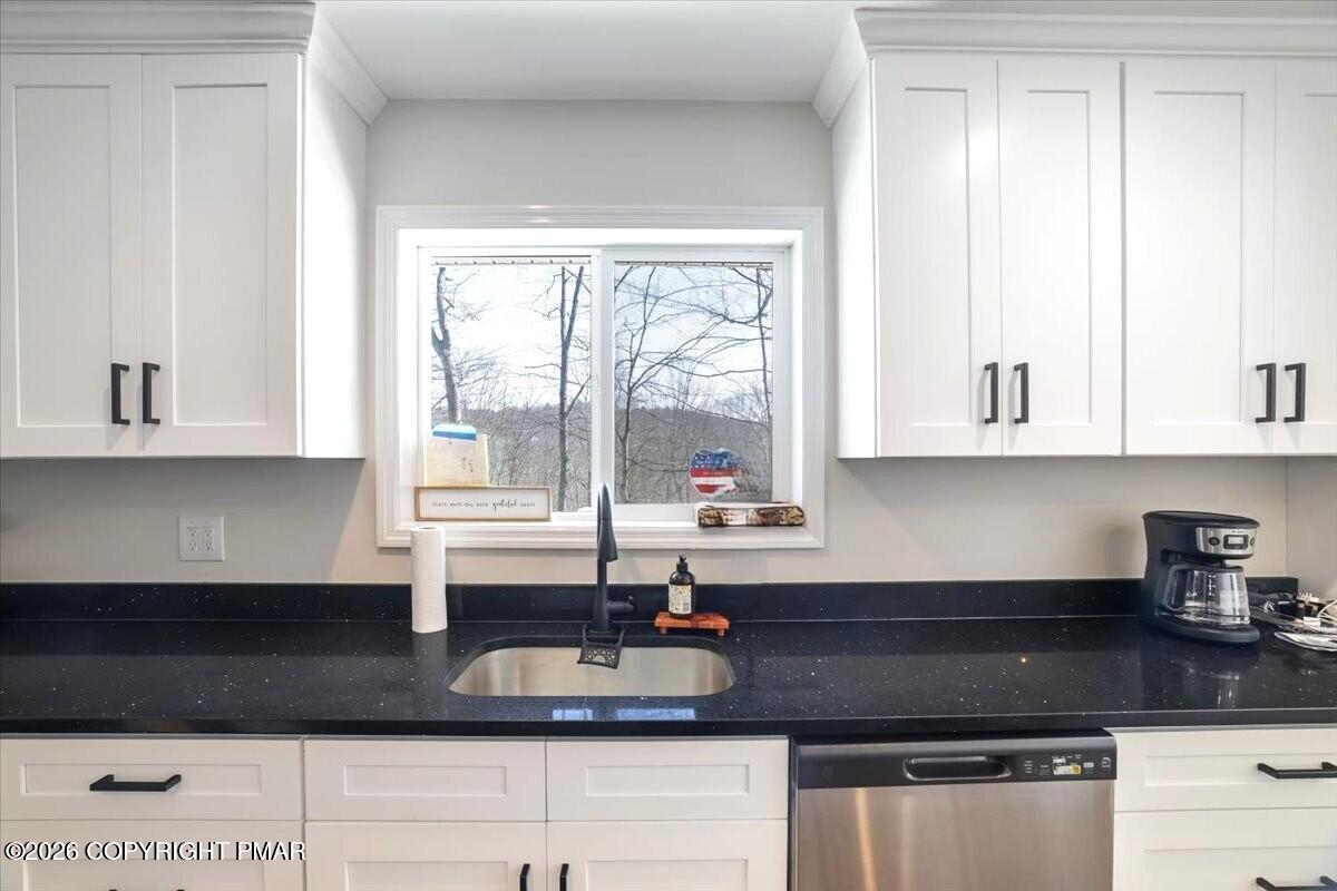 5873 Decker Road Bushkill, PA 18324 - Photo 31 of 57 a kitchen with granite countertop a sink a stove and cabinets