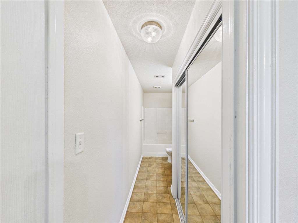 1001 Krenek Tap Road, Unit 603 College Station, TX 77840 - Photo 30 of 31 a view of a hallway with wooden floor and staircase