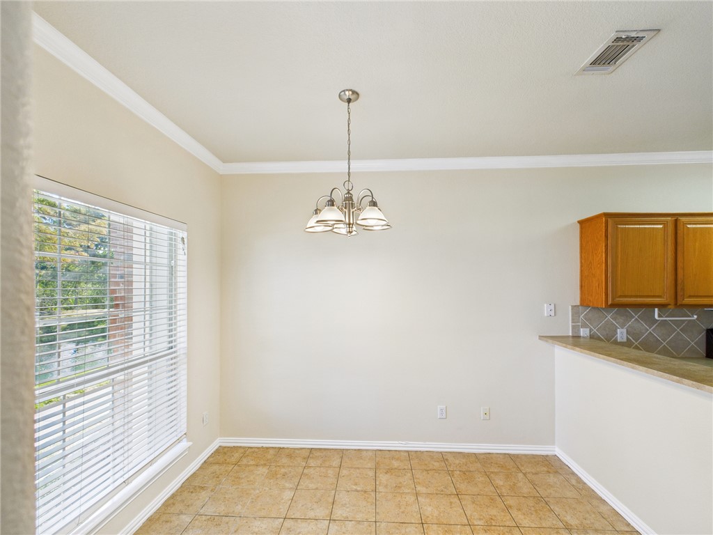 1001 Krenek Tap Road, Unit 603 College Station, TX 77840 - Photo 5 of 31 a bathroom with a granite countertop sink a window and a mirror