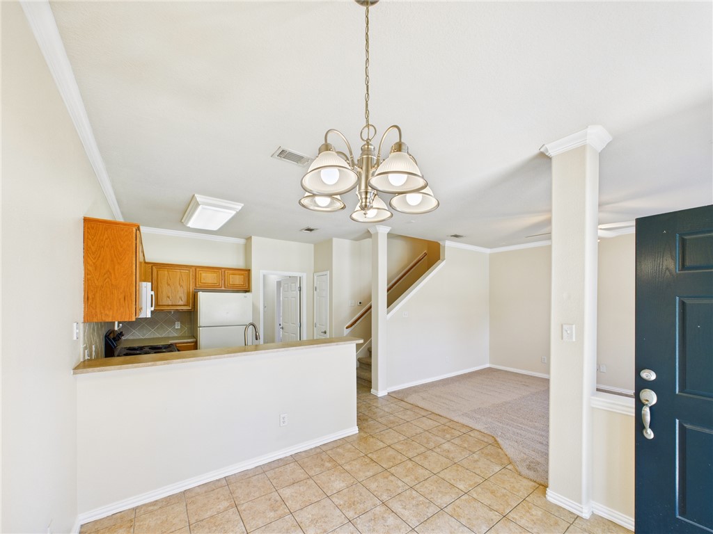 1001 Krenek Tap Road, Unit 603 College Station, TX 77840 - Photo 10 of 31 a view of a hallway with wooden floor and chandelier