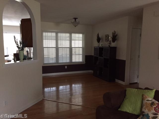 7602 Keating Drive Oak Ridge, NC 27310 - Photo 4 of 18 Dining Room. The dining area has a triple window with 2" blinds, chairrail molding....open to the kitchen & LR.