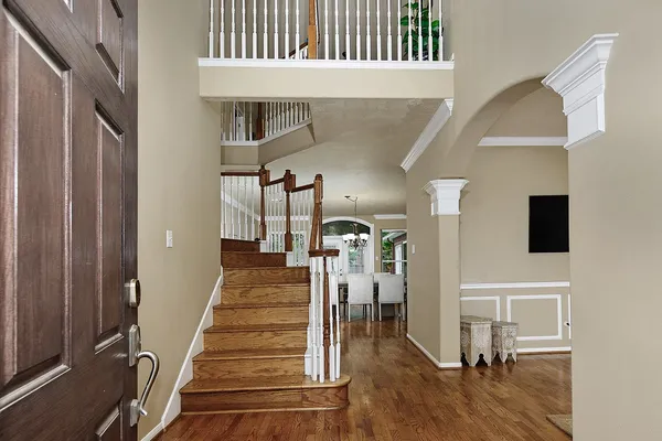 a view of entryway and hall with wooden floor
