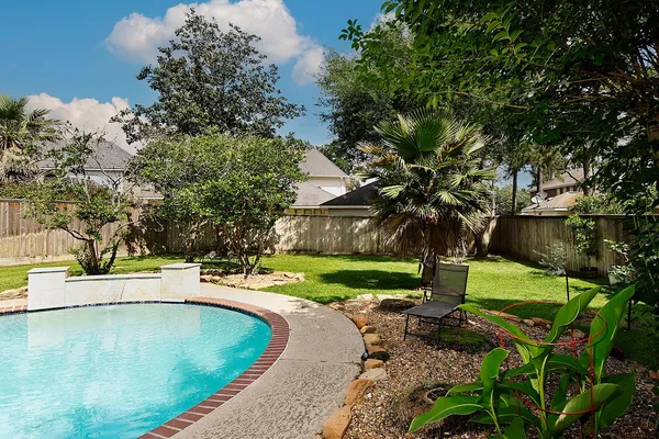 a view of a swimming pool with a yard