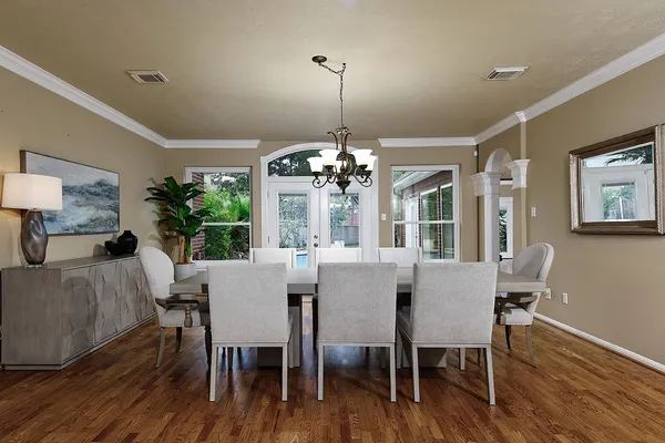 a view of a dining room with furniture wooden floor and chandelier