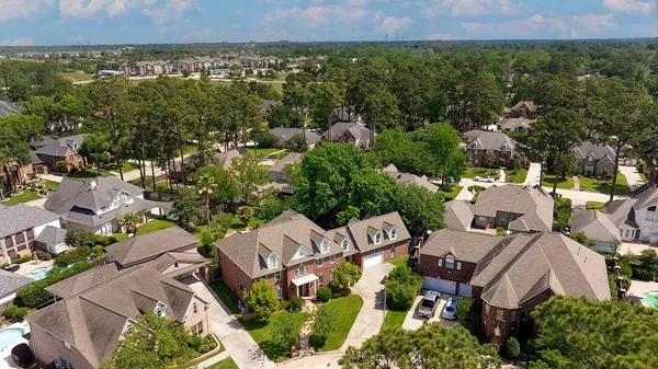 an aerial view of a house with garden space and street view