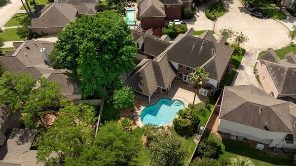 an aerial view of a house with outdoor space and a lake view