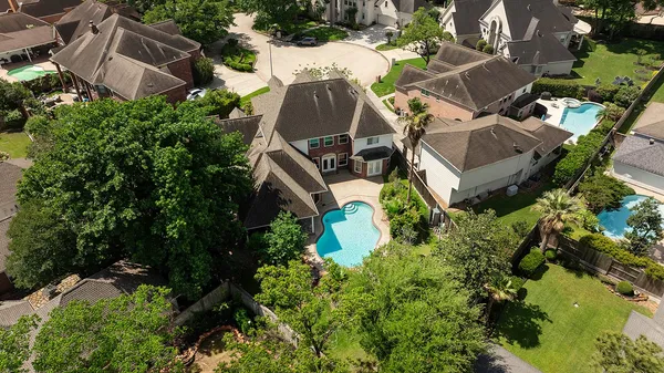 an aerial view of multiple houses with yard